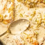 a skillet with creamy leek chicken and a serving spoon