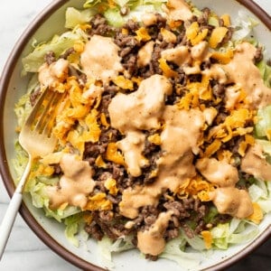 a bowl of big mac salad with a fork