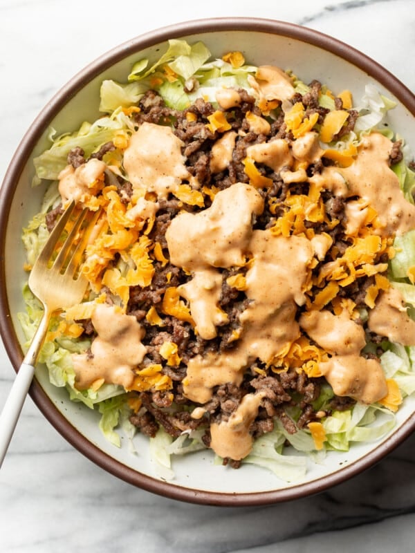 a bowl of big mac salad with a fork