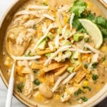 a bowl of creamy green chicken enchilada soup with a spoon