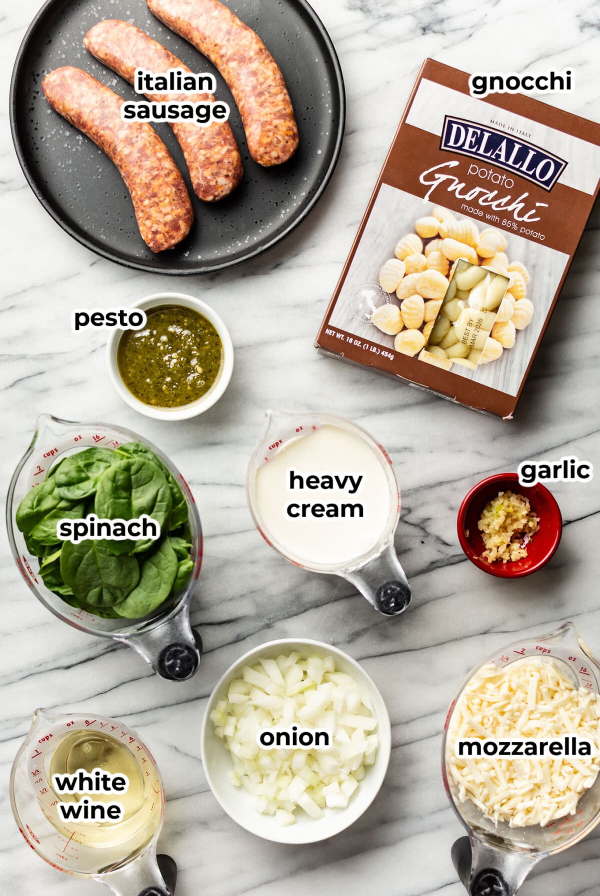 ingredients for pesto sausage gnocchi bake in prep bowls