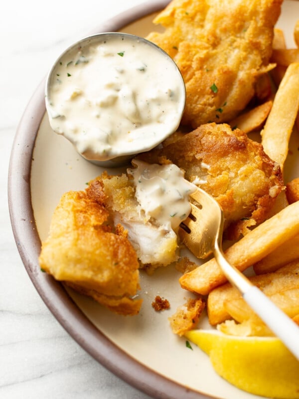 a plate with fish and chips and homemade tartar sauce