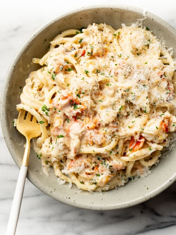 a bowl of crab pasta with a fork