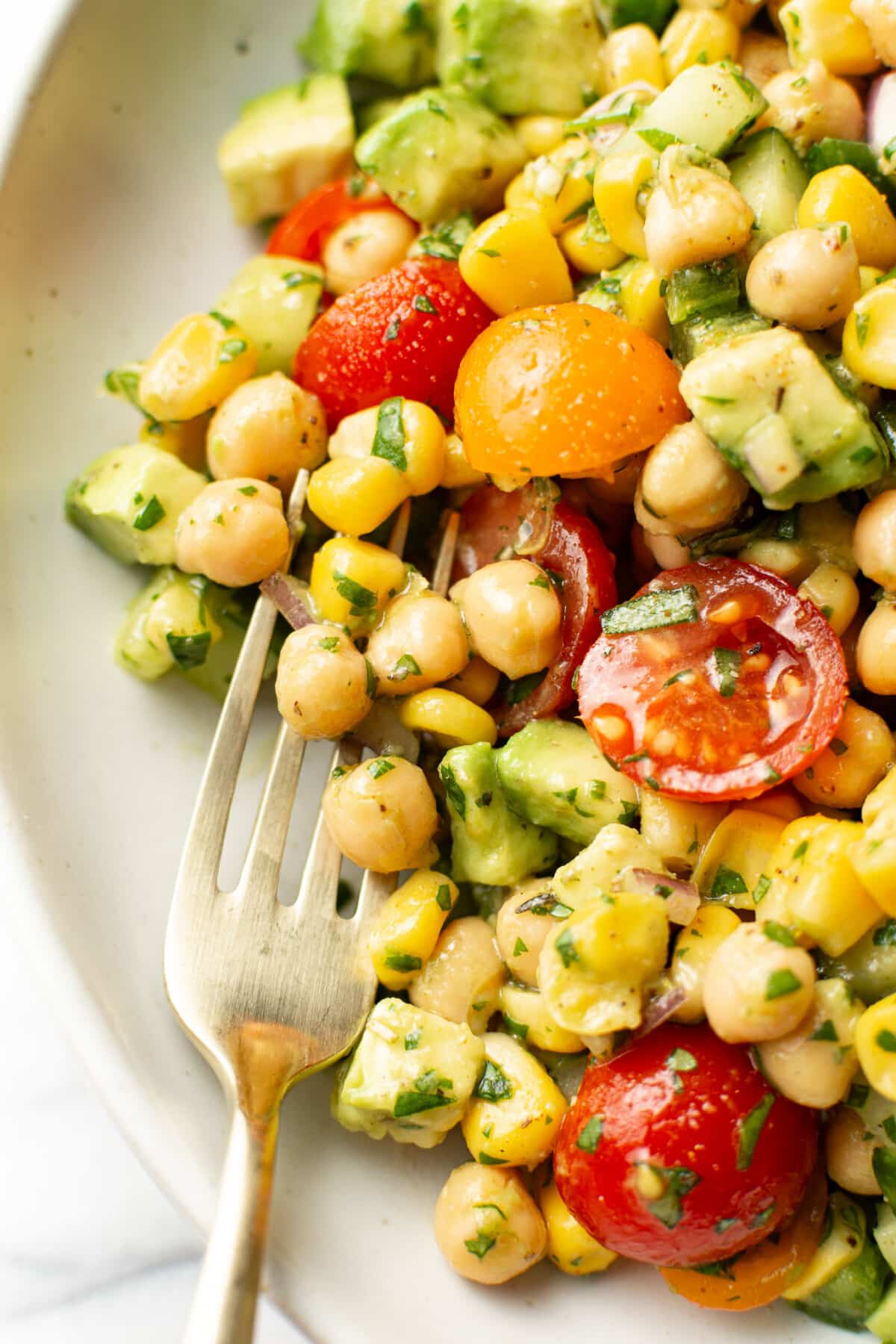 a bowl of chickpea salad with a fork