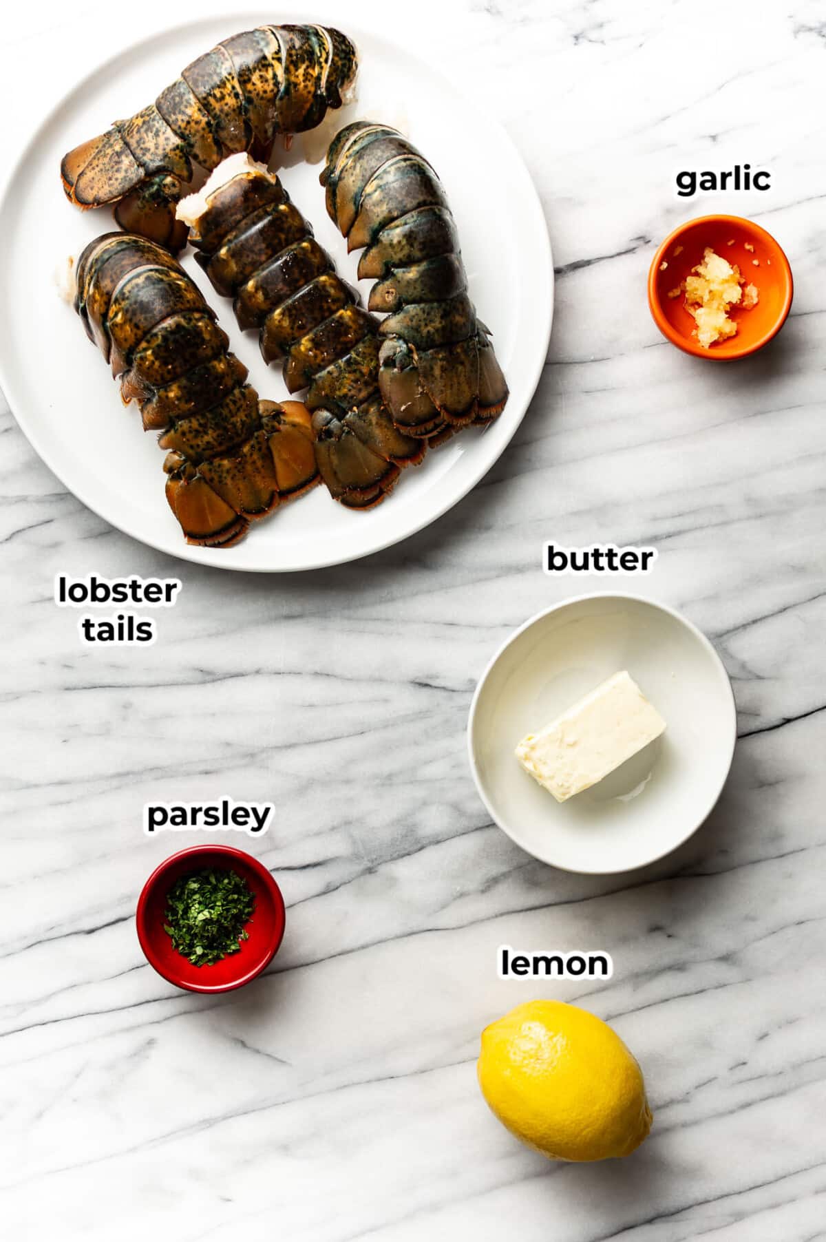 ingredients for garlic butter lobster tails in prep bowls