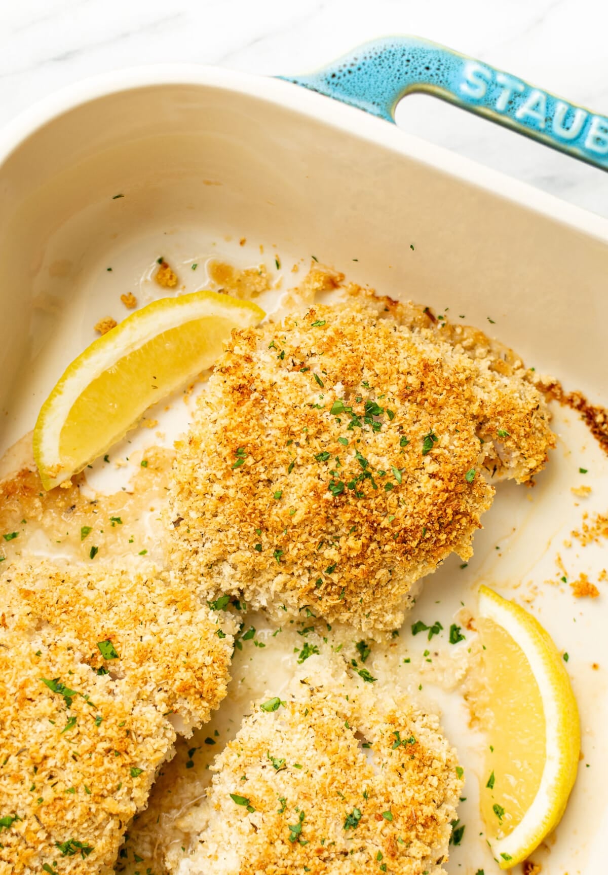 This easy parmesan panko baked cod recipe has melt-in-your-mouth flaky fish coated in an irresistibly crunchy and cheesy topping! It's a simple 30-minute dish with little prep.